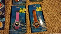 Two packaged Slam Band digital watches