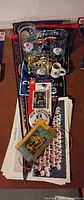 Lot overview showing pennant, glasses, mini mug, cards, pin