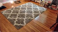 Full view of rug on hardwood floor showing color and pattern