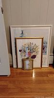 All three framed prints grouped: white museum poster, large gold floral, small gold floral
