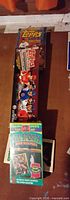 Stacked view of both Topps card set boxes, VHS tape, partial book