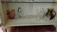 Shelf view showing entire assortment of glassware pieces