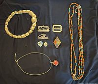 overview of all nine jewelry pieces on dark background