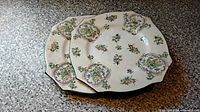 Two octagonal floral dinner plates with hand-painted decoration