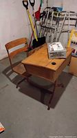 Desk with attached chair and boxed microscope on top