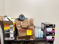 Overall lot showing Feit bulb boxes, Glad box, paper bag and bag rolls