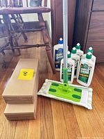 assembled spray mop with pad, six finish bottles, one cleaner bottle, two sealed boxes