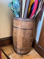 Barrel stand with floral umbrella visible