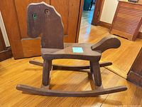 Full side view of wooden rocking horse
