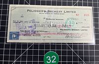 Full view of cancelled cheque showing text, excise stamp, cancellation marks and amount