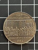 Reverse of 1982 Canadian dollar coin showing Fathers of Confederation design and inscriptions