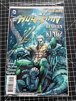 Front cover of Aquaman #18 comic in protective sleeve