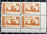 Front view of plate block of four stamps with selvedge showing plate inscription