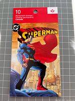 Front cover showing Superman artwork and booklet header indicating 10 permanent stamps