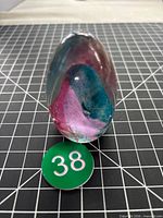 Front view of glass egg with color swirls