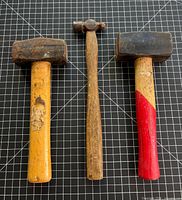 Front view of all three hammers on grid background