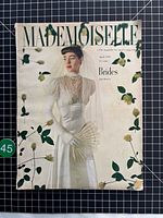 Front cover showing title, bride in white gown with fan