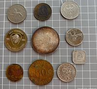 Obverse sides of ten assorted coins and tokens