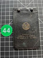 Front cover of notebook showing Dunlop Fort logo and business imprint