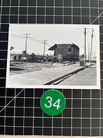 Full photograph on grid background with green 34 tag