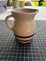 Left side view of Robinson Ransbottom pitcher showing blue stripes and handle