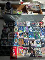 Open wooden drawer packed with cards and sampling of laid-out vintage and modern cards