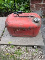 Full view of red Kiekhaefer Mercury outboard fuel tank