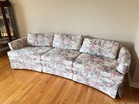 Full view of floral pastel 3-seater sofa
