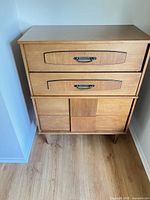 Front view of tall chest showing overall design and finish