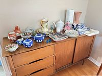 Full overview of all porcelain, glass and dish items on credenza