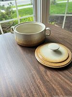 Two stoneware covered casseroles with lids removed, showing interior glaze and exterior ombre glaze