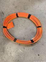 Full view of coiled orange cable