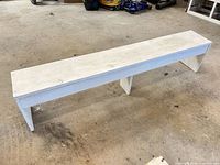 full view of white painted pine bench on workshop floor
