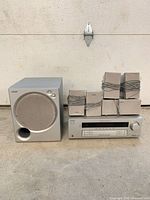 Group shot of receiver, subwoofer, and six satellite speakers