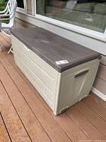 Full view of Keter beige/brown deck box on deck