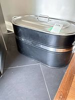 Black painted metal coal carrier with lid and chrome trim