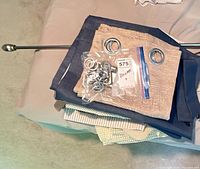 All items grouped: rod, drapes, rings, rug pads