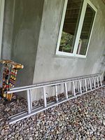 Full side view of ladder leaning against wall