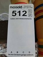 MaxSold lot tag beside stand