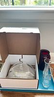 Box with clear glass dome, red vase, clear vase