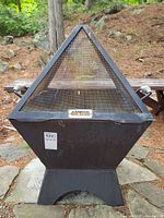 Front view of Iron Embers fire pit showing mesh screen and label