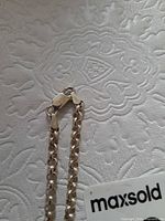 Close-up of clasp ends showing lobster clasp and tags