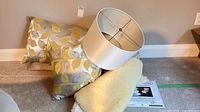 Group view of pillows, lampshade, sheepskin and product booklet