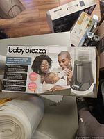 Front of sealed Baby Brezza warmer box showing product image and branding