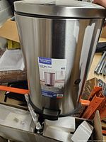 Front view of stainless steel step can showing label and pedal