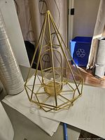 Full view of candle holder showing shape and gold finish