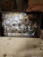 Interior view of tray showing antique world map graphic