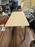 Full top view of table showing wood surface and all four metal legs