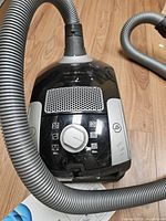 Top view of Miele canister vacuum showing controls and attached hose