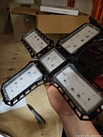 Foldable LED bulb fully opened showing four light panels